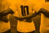Team players creating a chain. The center player has the number ten on his back.